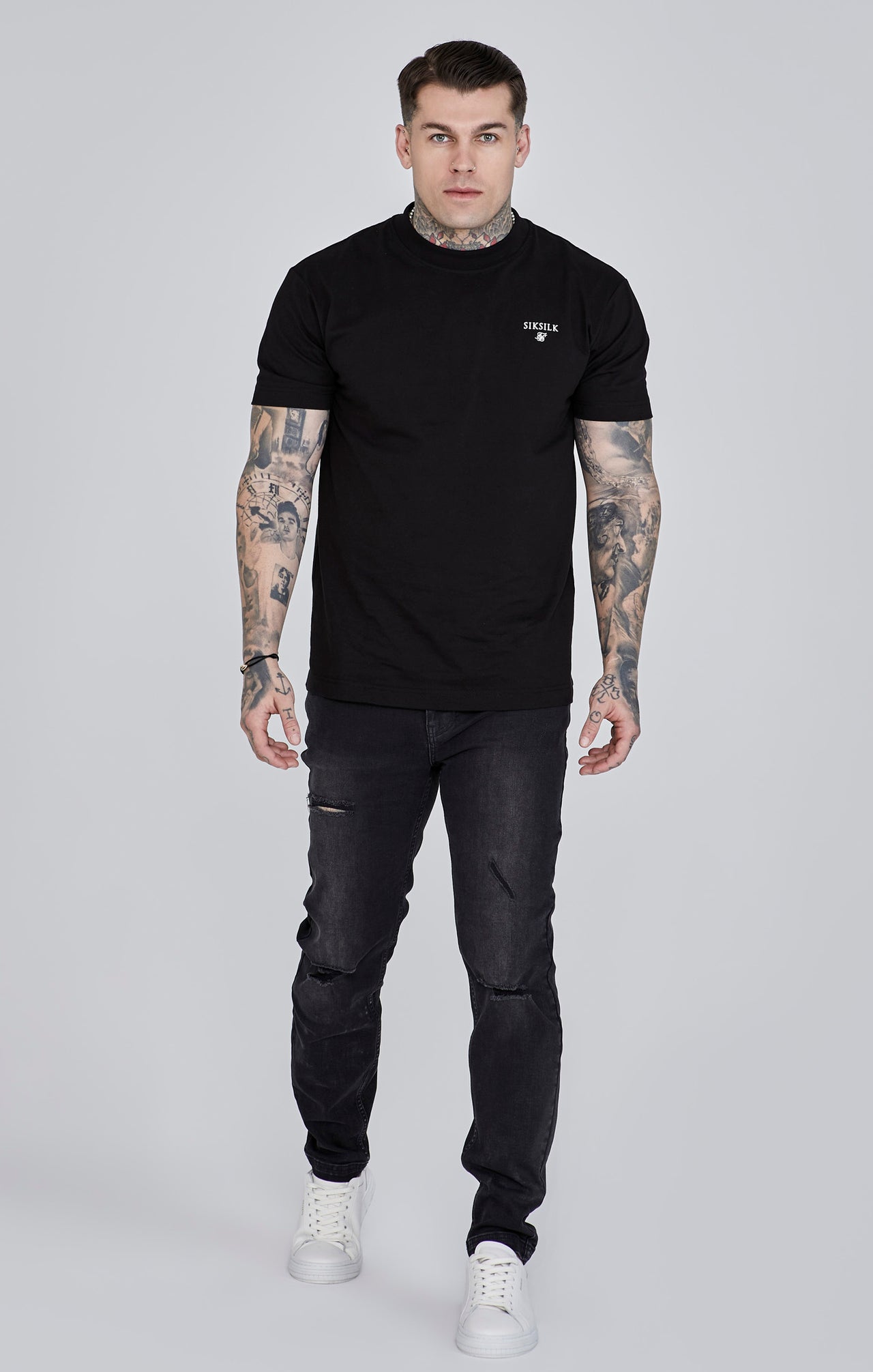 Jeans slim fit invecchiati in nero Jeans SikSilk