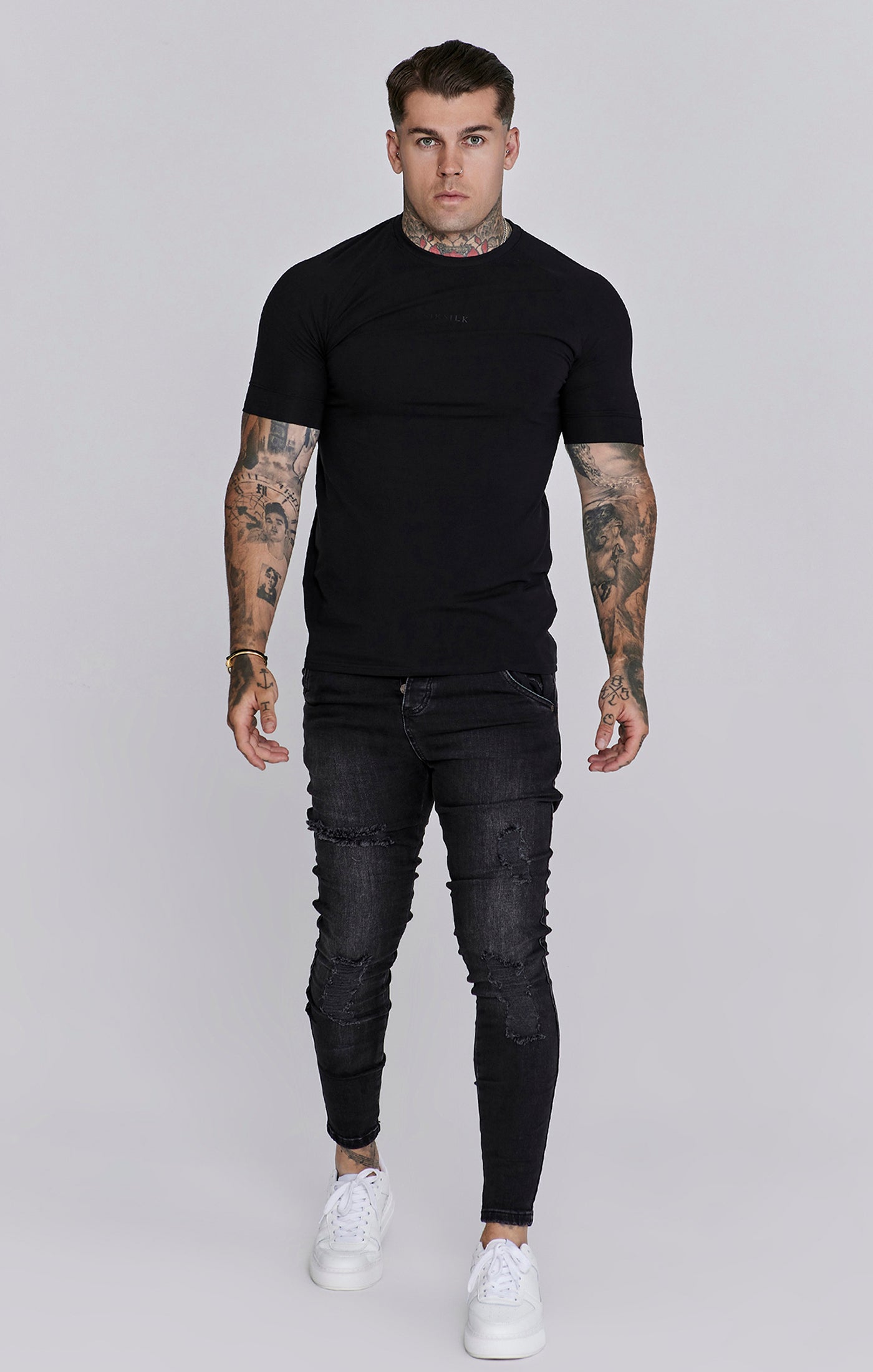 Jeans skinny invecchiati in nero SikSilk