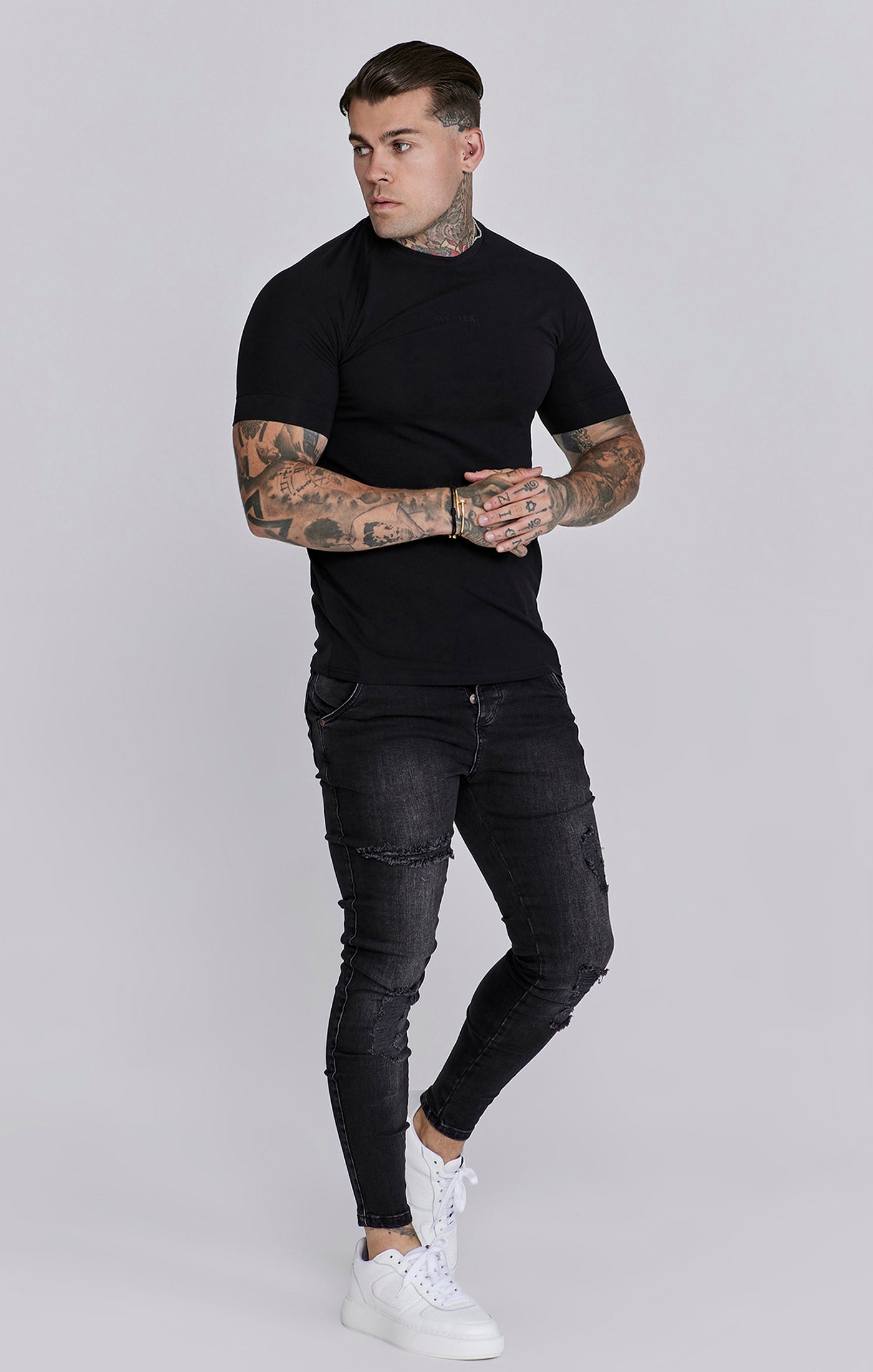 Jeans skinny invecchiati in nero SikSilk