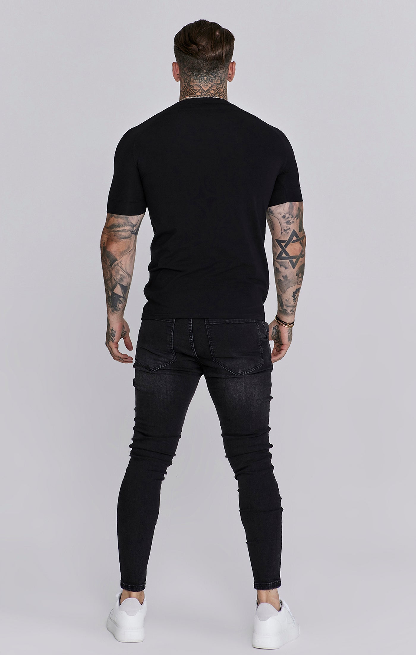 Jeans skinny invecchiati in nero SikSilk