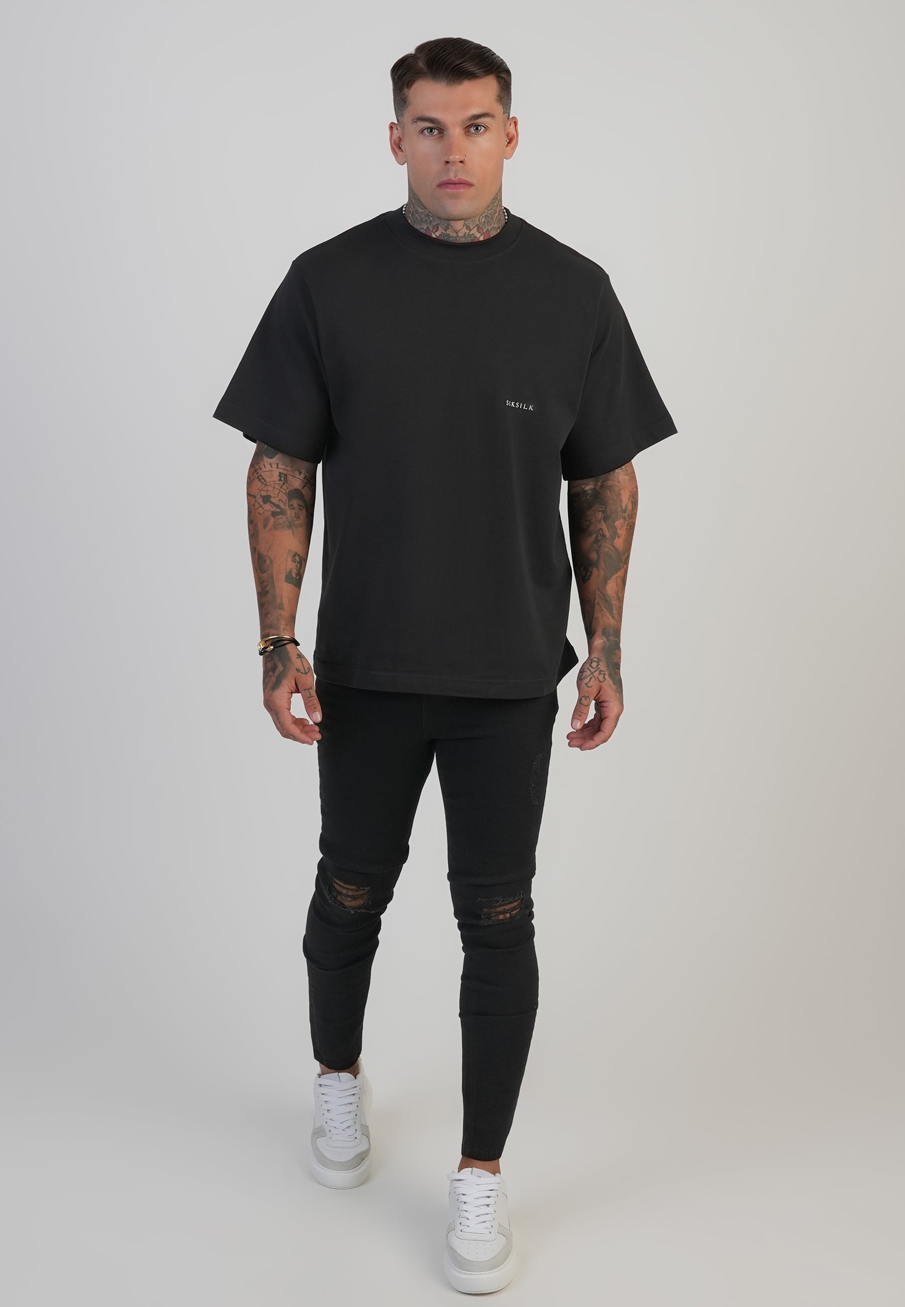 Jeans skinny invecchiati in nero SikSilk