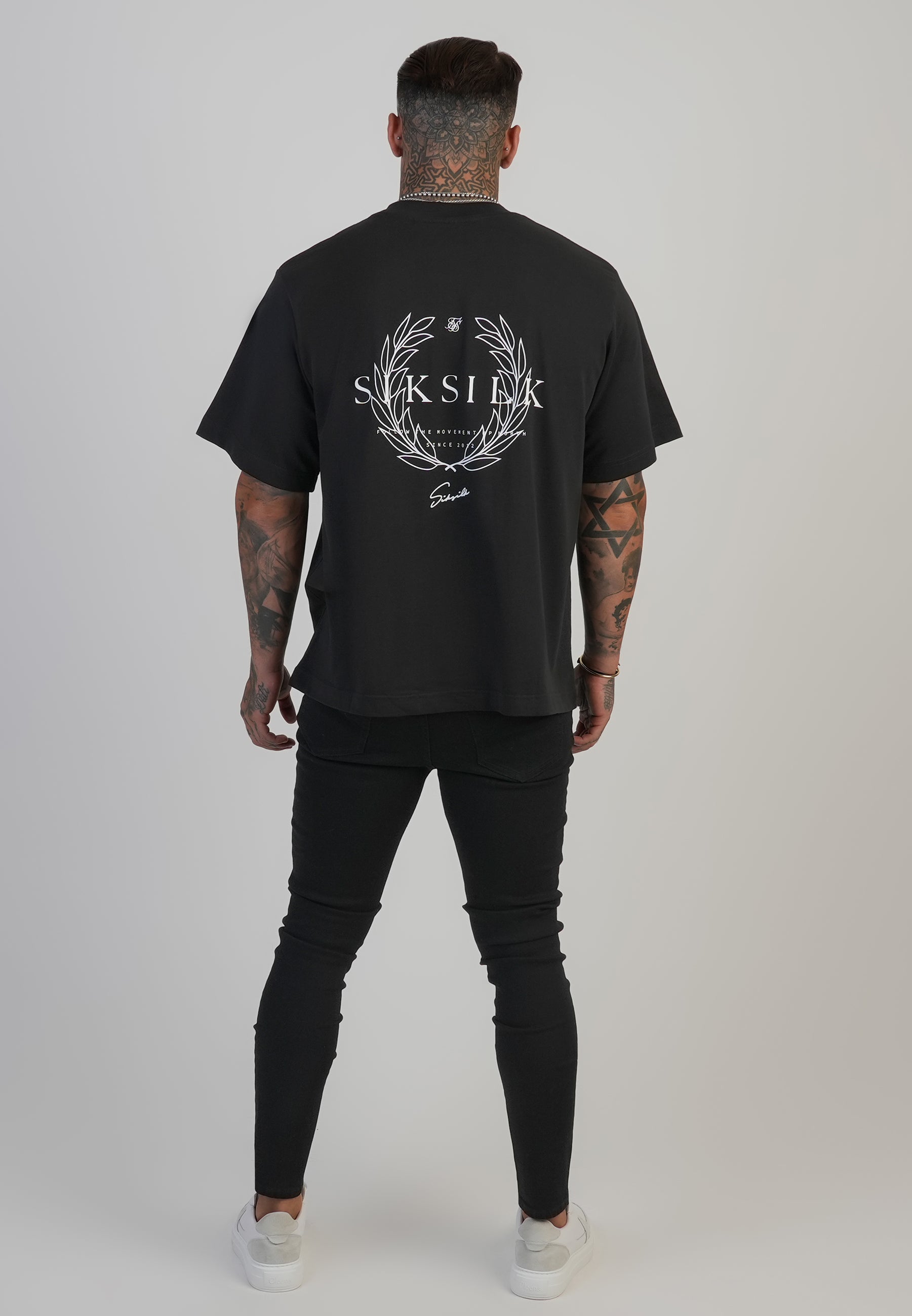 Jeans skinny invecchiati in nero SikSilk