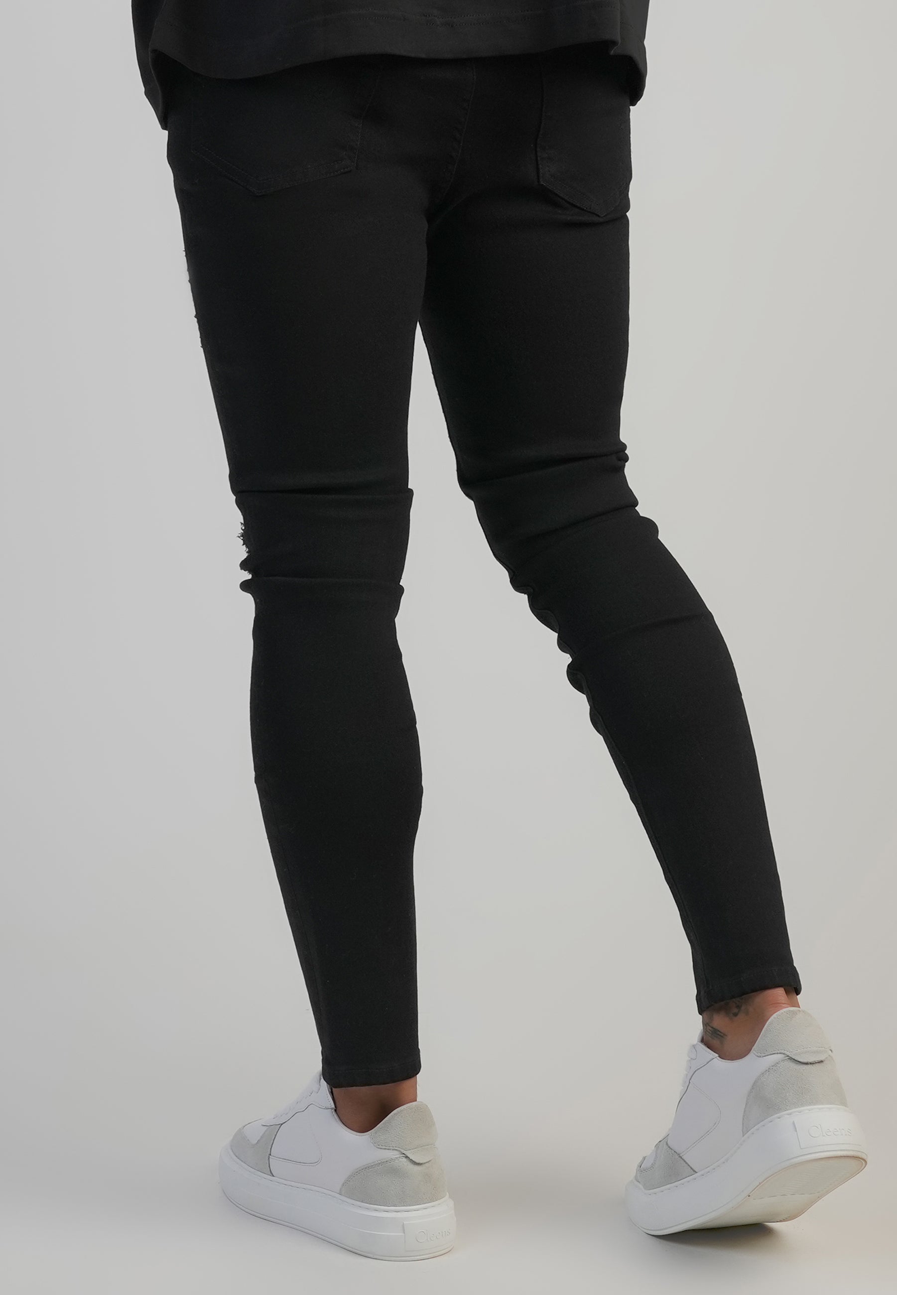 Jeans skinny invecchiati in nero SikSilk