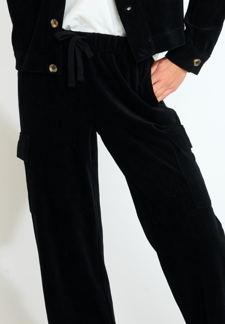 BEYOND-QUANDARY Pantaloni da jogging in velluto a coste in Noir Pantaloni Banana Moon