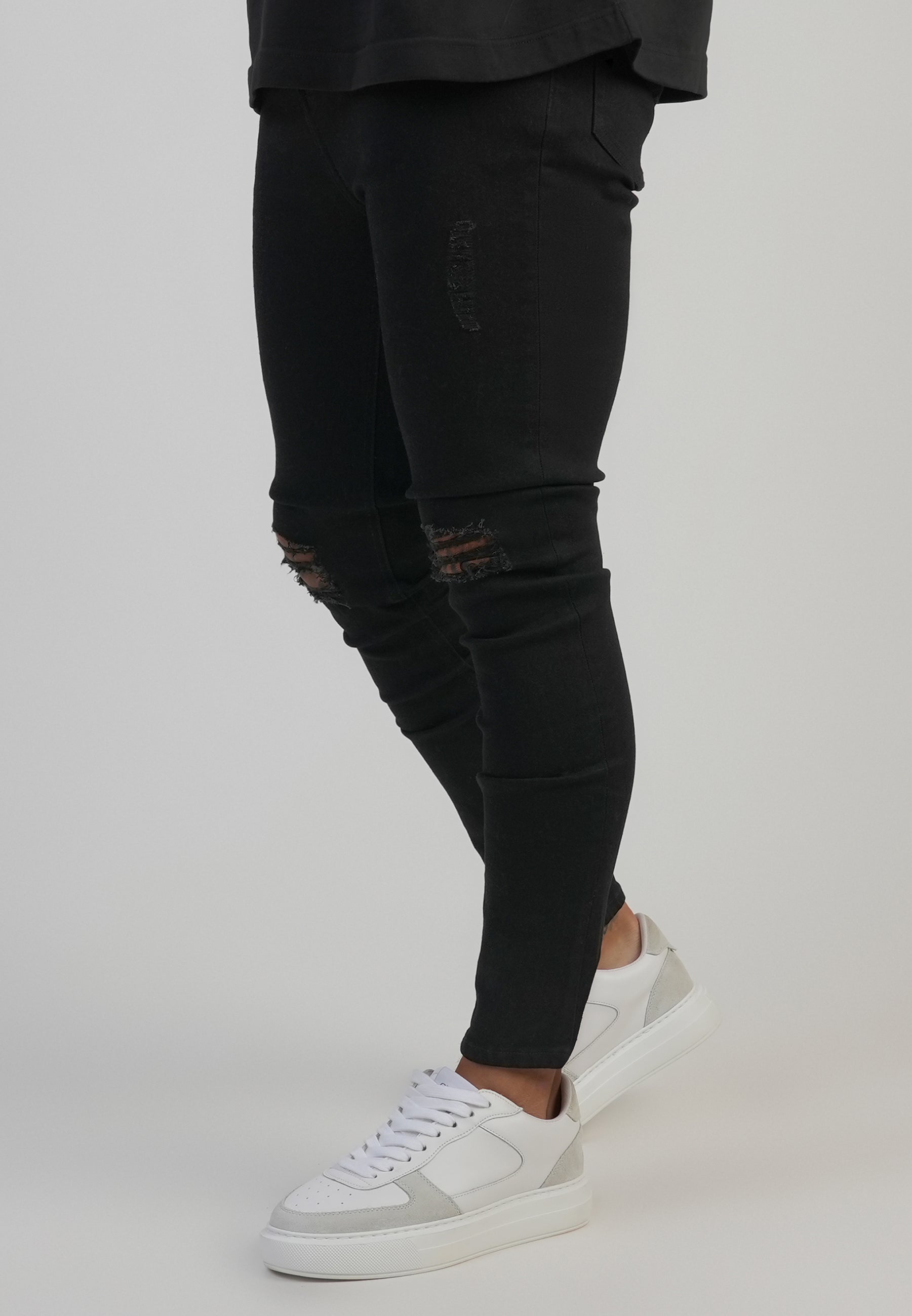 Jeans skinny invecchiati in nero SikSilk